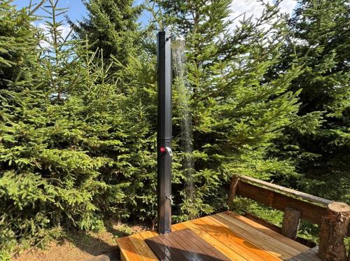 a pole sitting next to a wooden bench at ALMNEST - LACHTAL in Lachtal