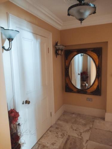 a hallway with a door and a mirror at Charlesfort House in Ferns