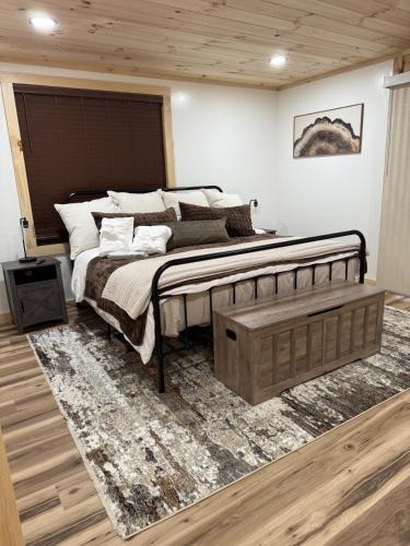 a bedroom with a large bed and a rug at The Brady Retreat Hot tub and pool in McArthur