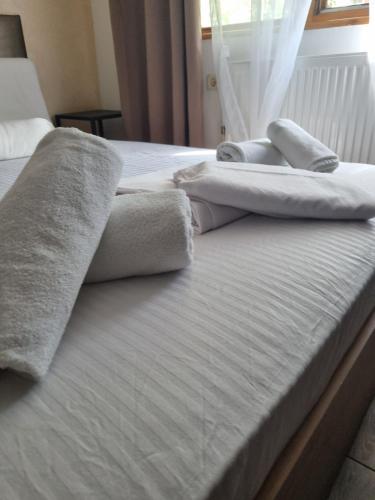 two beds with towels sitting on top of them at Family Hotel Amor in Ruse
