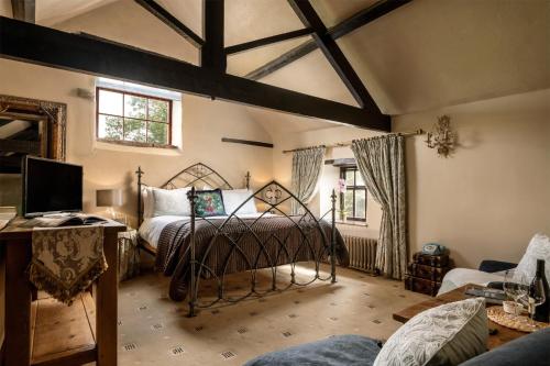 a bedroom with a bed and a tv in a room at Dannah Farm Country House in Shottle