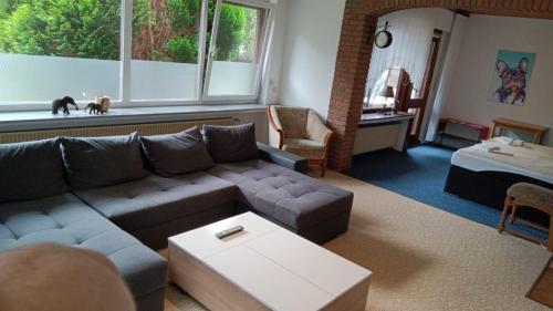 a living room with a couch and a table at Ferienhaus Strandlöper Reiners in Horumersiel