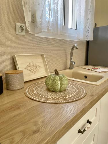 a pumpkin sitting on a counter next to a sink at Anna's House in Xerokampos
