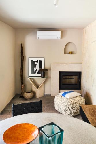 a living room with a table and a fireplace at Can Pardis in Cala Llonga