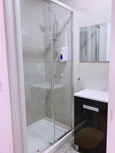 a shower with a glass door in a bathroom at El Castillo in Alcalá de Guadaira