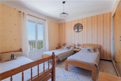 Postel nebo postele na pokoji v ubytování Les Albères