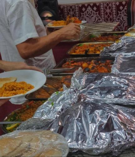 a buffet line with many different types of food at Wadi Rum, Hala bubbles in Wadi Rum