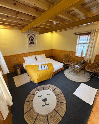 a bedroom with a bed with a bear on the floor at Astro Monks in Kaja