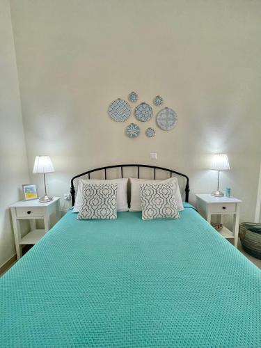 a bedroom with a green bed with two night stands at Anna's House in Xerokampos