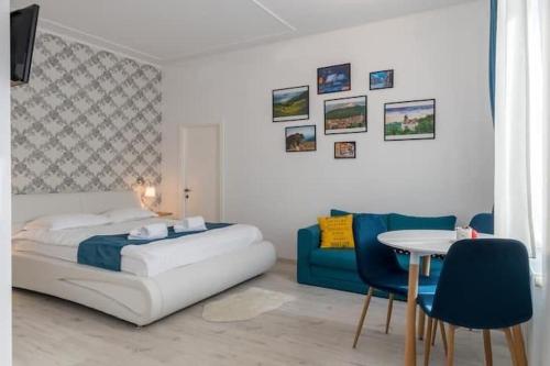 a bedroom with a bed and a table and chairs at Centru Vechi Brasov in Braşov