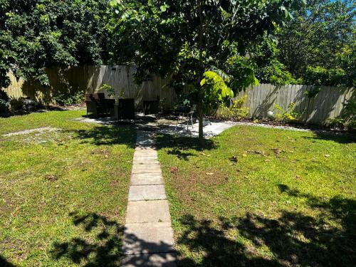 a stepping stone path in a yard with a tree at Maria's Tiny Barn in Homestead