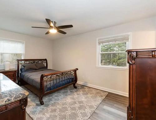 a bedroom with a bed and a ceiling fan at Family Retreat with NEW POOL - Durham Upstairs Unit in Durham