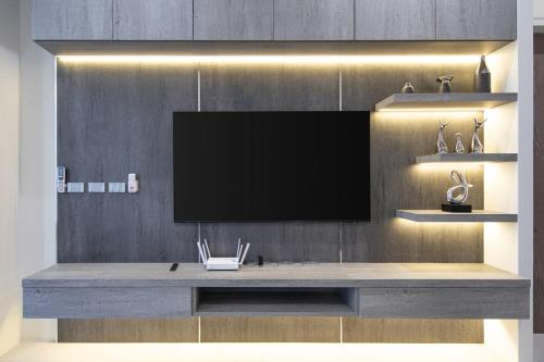 a large entertainment center with a television on a wall at Luxury Modern Villa Phuket - Thala in Phuket