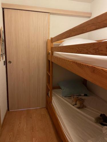 a room with two bunk beds and a door at OZ station 3300m studio mountain in Oz
