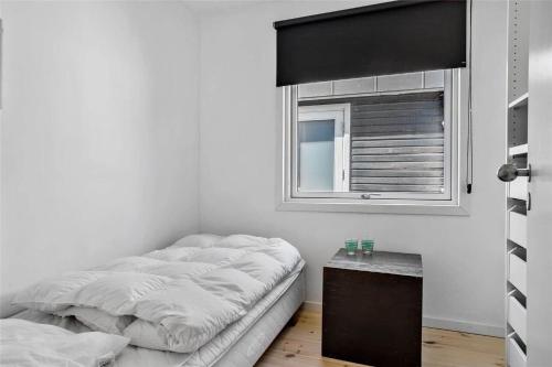 a bedroom with a bed and a window at 30007-Malling-Hyldevaenget-9 in Malling
