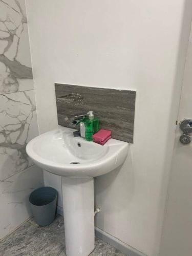 a bathroom with a white sink in a room at Firdaus Loft Haven in Huddersfield in Golcar