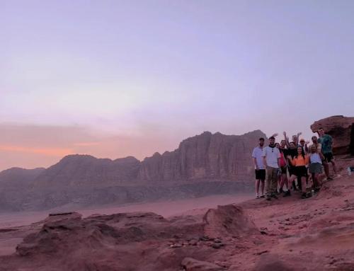 a group of people standing on top of a mountain at Wadi Rum, Hala bubbles in Wadi Rum