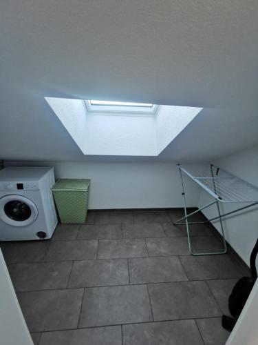 a room with a washing machine and a window at Wohlfühloase 