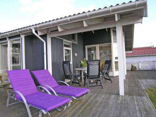 a deck with purple lounge chairs and a table at 30098-Malling-Norsmindevej-171-K in Malling