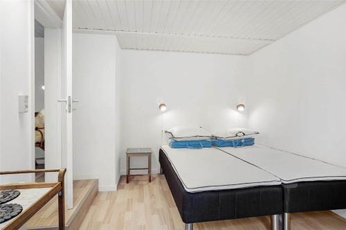 a bedroom with a bed in a white room at 30609-Odder-Spovevej-1 in Odder