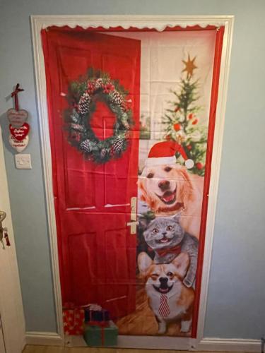 a christmas door with a picture of a dog and a cat at Edinburgh Home from Home in EDI