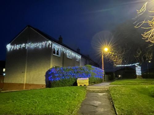 a building with christmas lights on it at night at Edinburgh Home from Home in EDI