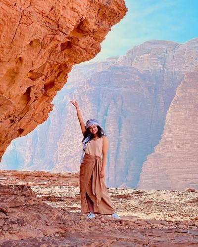 a woman standing in front of a canyon at Wadi Rum, Hala bubbles in Wadi Rum