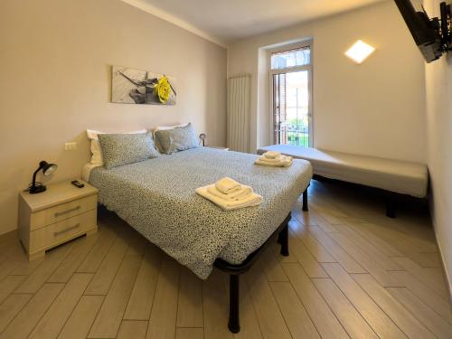 a bedroom with a bed with two towels on it at BelSorrisoVarese - Elegance City Residence Private Parking -Reservation Required- in Varese