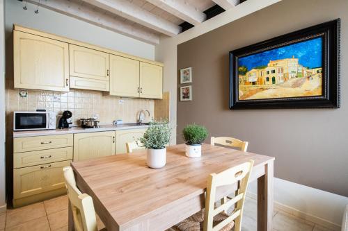 a kitchen with a wooden table in a kitchen at Residence Cà di Capri in Bussolengo