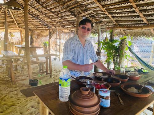 a man standing in front of a table with food at Secret Paradise Panama in Panama