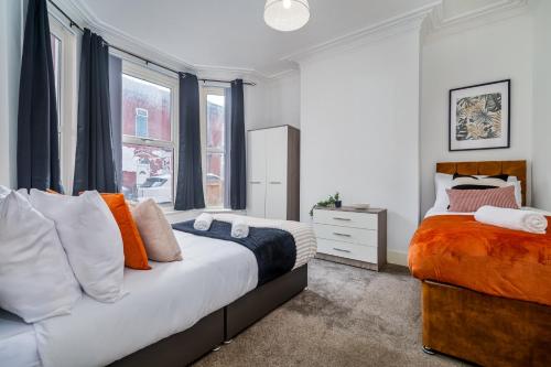 a bedroom with two beds and a window at Birkenhead Haven - Sleeps 14 - Family and Group Stay in Birkenhead