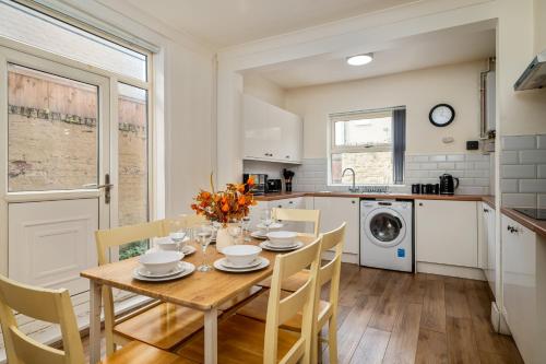 a kitchen and dining room with a table and chairs at Birkenhead Haven - Sleeps 14 - Family and Group Stay in Birkenhead