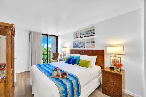 a bedroom with a large bed and a window at Napili Point by KBM Resorts in Kaanapali