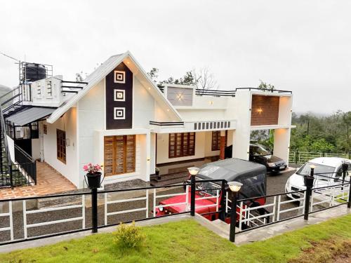 a house with a car parked in front of it at Nature View Home Stay in Vagamon
