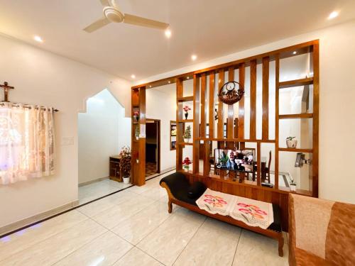 a living room with a couch and a ceiling fan at Nature View Home Stay in Vagamon