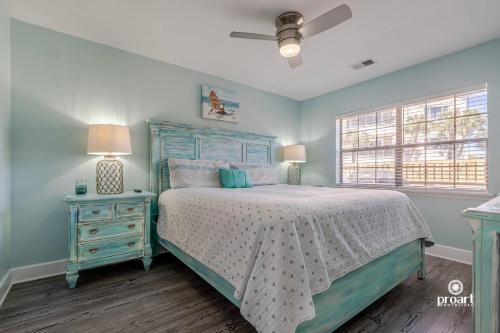 a blue bedroom with a bed and a nightstand with a bed sidx sidx sidx at Mermaid's Place* 0.6 miles to beach* monthly disc in Destin