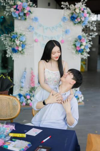 a woman sitting on the lap of a man at The Horizon Groove Hotel in Ban Khlong