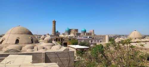 a view of a city with domes and mosques at Jumadaler Дворец эмира в старом городе in Bukhara