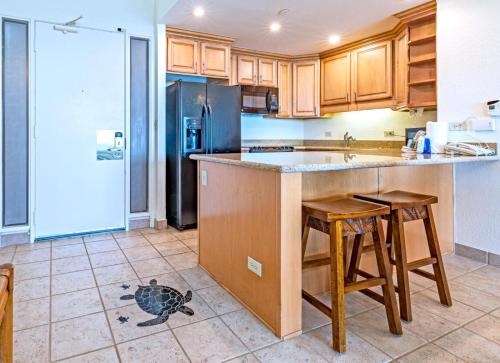 a kitchen with a turtle on the floor at Napili Point by KBM Resorts in Kaanapali
