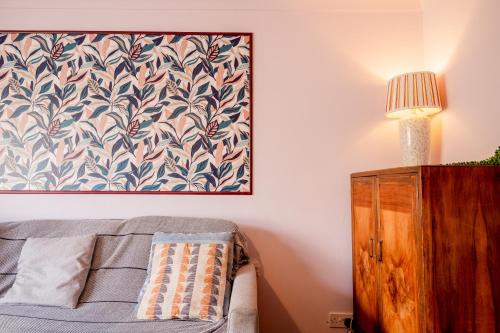 a bedroom with a bed and a painting on the wall at 1 Hales Orchard in Worcester