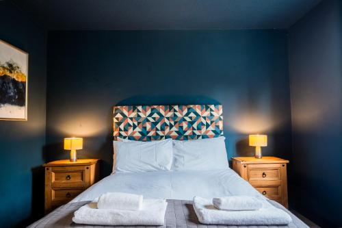 a bedroom with a bed with two towels on it at 1 Hales Orchard in Worcester