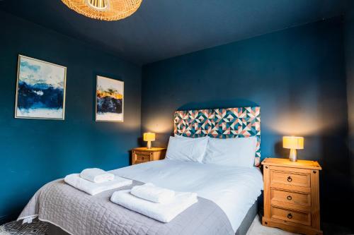 a bedroom with a bed with two towels on it at 1 Hales Orchard in Worcester