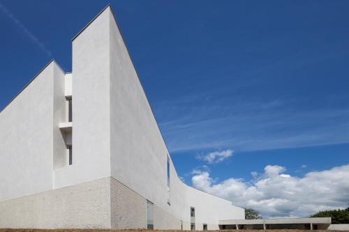 a white building with a sky in the background at Best Western Plus Hotel Divona Cahors in Cahors