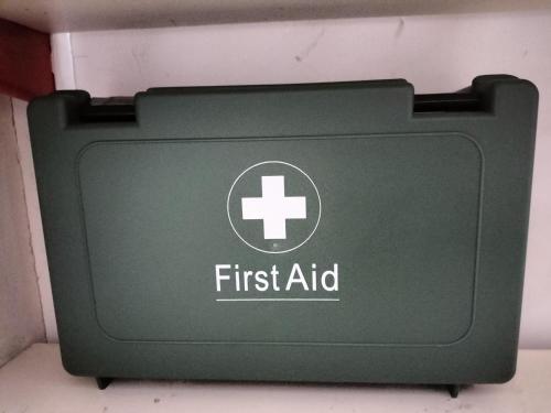 a green first aid box with a white cross on it at Fig Tree Cottage 