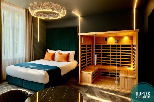 a hotel room with a bed with orange pillows at LiFE VOYAGE RESIDENCE & SPA - Strasbourg's City Center Luxury Experience in Strasbourg