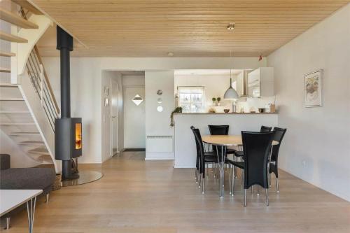 a dining room and kitchen with a table and chairs at 40143-Juelsminde-Strandengen-75 in Juelsminde