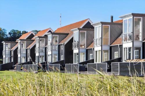 a row of houses with red roofs at 40143-Juelsminde-Strandengen-75 in Juelsminde