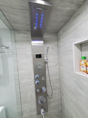 a shower with a glass door in a bathroom at 3 bdrm 3 bath bsmt Brampton Toronto, Sleeps 16 in Brampton