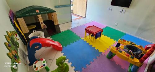 a childs play room with toys on the floor at Rio Búzios Beach Hotel in Búzios