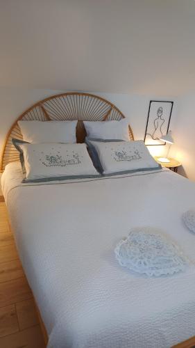 a large white bed with white pillows on it at lepetitprince.aquitaine in Pessac